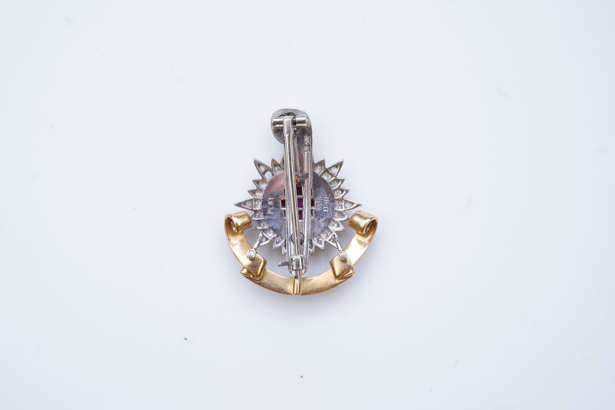 A ruby, enamel and diamond Royal Sussex Regiment badge, mid 20th century